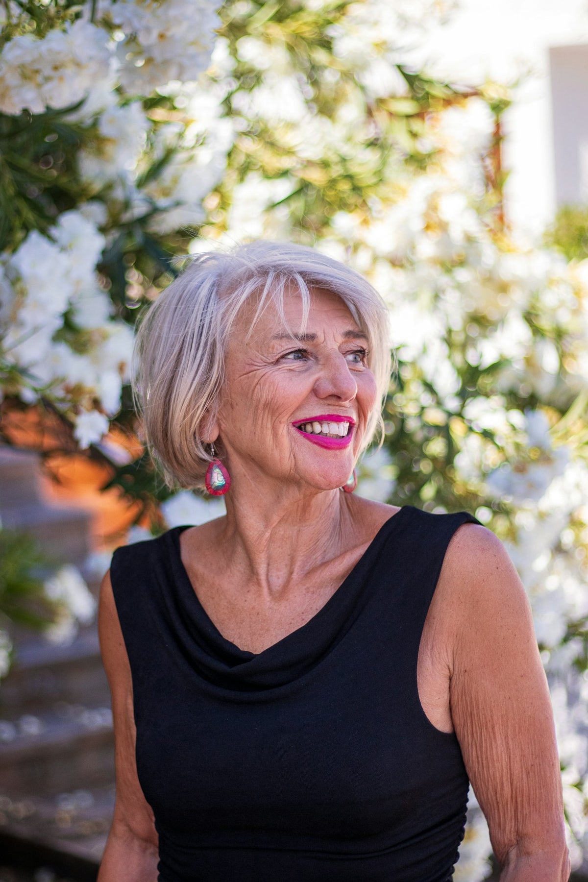 Smiling woman with silver hair in a black dress